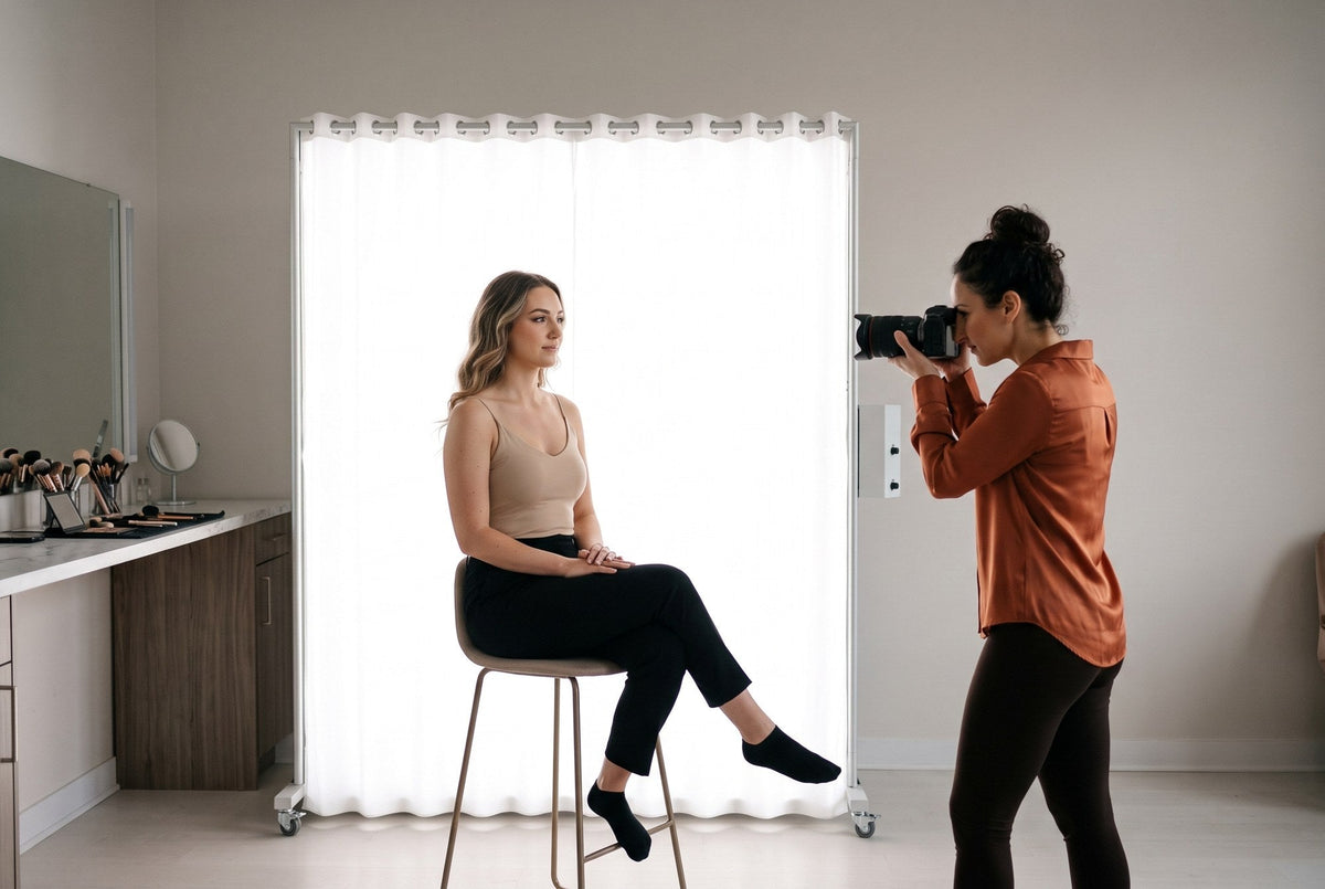 Photographer shooting a beauty close-up of a client lit by a LEDWindow PRO panel next to a makeup station