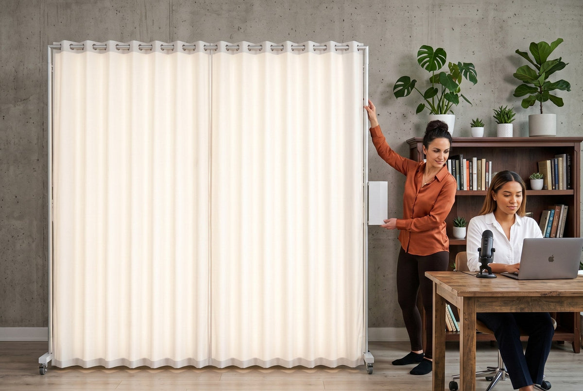 Content creator at a desk with laptop and microphone lit by a LEDWindow PRO panel as the photographer adjusts it
