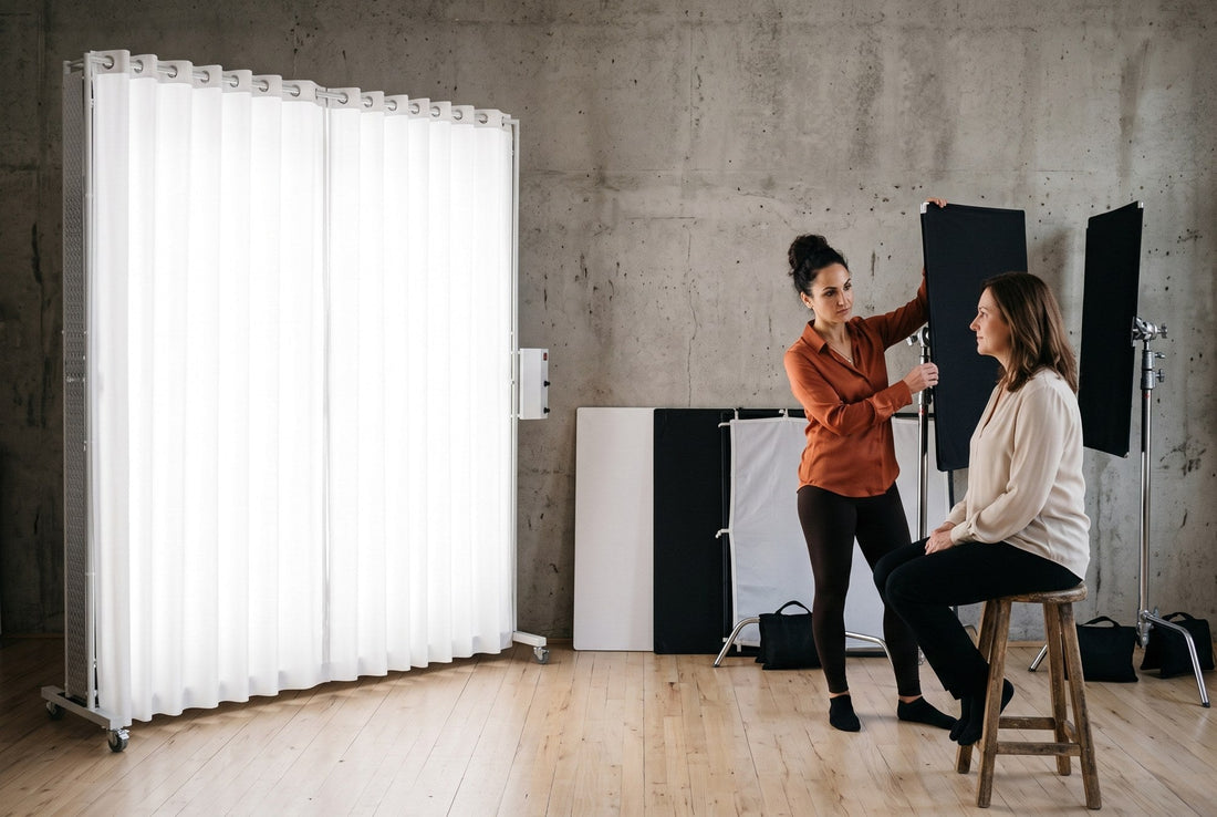Photographer holding a black flag near a client, with V-flats and a diffusion frame beside a LEDWindow PRO panel