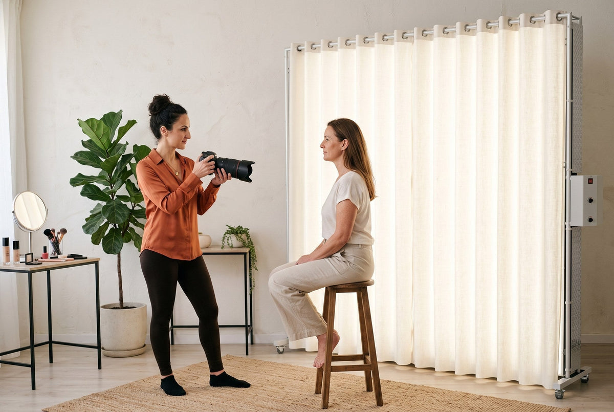 Photographer Lucy shooting a beauty portrait of a mature woman seated beside a lit LEDWindow PRO window-style continuous light with a soft white curtain